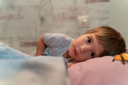 Porter the child who is lying on the couch