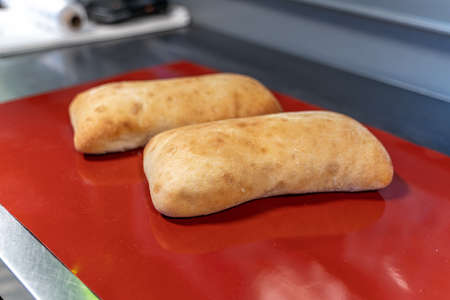 Ciabatta is on the red table. out from ovenの写真素材