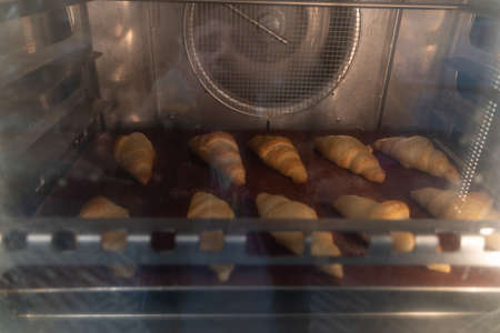 Lots of croissants baked in the ovenの写真素材