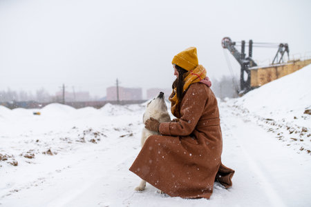 Girl walks with her dog husky breedの写真素材