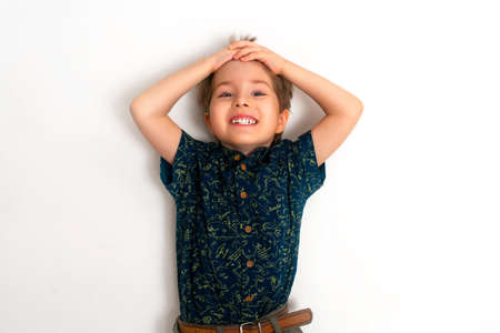 The little boy laughs with a white smile. White background