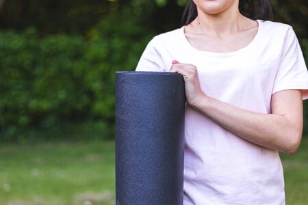Young woman holding yoga matの写真素材