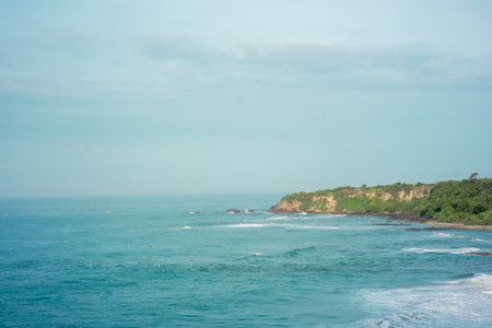 panorama of the scenic view of the beach from a green cliff with very large sea waves. at santolo...