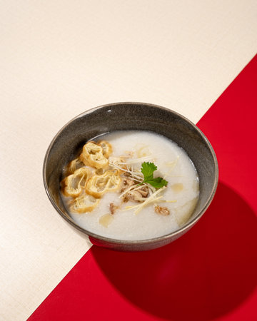 Porridge with dumplings, chicken and spring onions.の写真素材