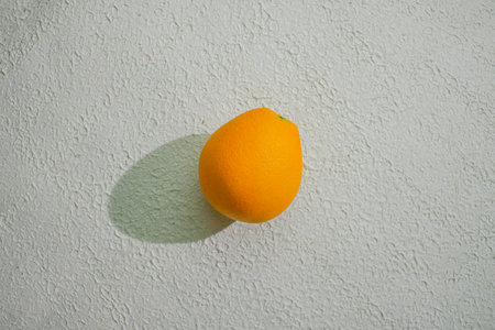 A vibrant orange isolated on a clean white background, representing freshness, health, and natural citrus goodness, ideal for food related visualsの写真素材