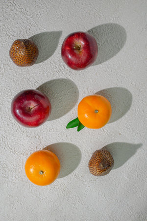 A vibrant orange, apple and snakefruit isolated on a clean white background, representing freshness, health, and natural citrus goodness, ideal for food related visualsの写真素材