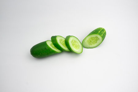 Fresh cucumber slices. isolated in white backgroundの写真素材