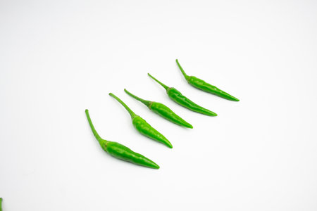 Green cayenne peppers in clusters. isolated on white background.の写真素材