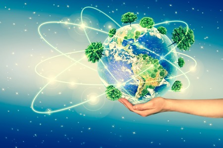Ecological concept of the environment with the cultivation of trees on the ground in the hands....