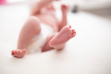 Gentle baby feet. Gentle blurred background of the feet and heels of a newborn