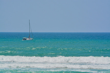 A sailboat on the Mediterranean Sea in Ashkelon, Israelの写真素材