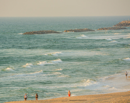 People walking on the beach of the Mediterranean Sea in Israelのeditorial素材