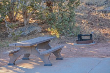 Campsite with a fire pit and picnic table at Fool Hollow Lake in Show Low, Navajo County, Apache...