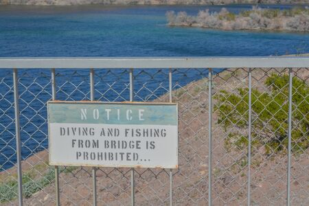 Diving and Fishing From Bridge is Prohibited Sign at the Arizona Nevada border on Lake Mohave, Mohave County, Arizona USAの写真素材