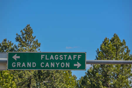 Flagstaff and Grand Canyon Road Sign in the Arizona Pine Forest. Flagstaff, Arizonaの写真素材