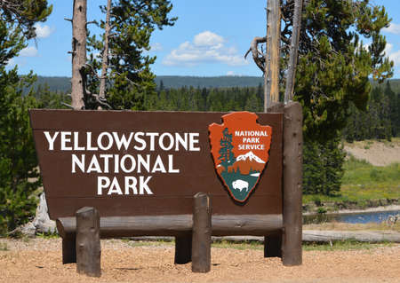 The sign for Yellowstone National Park in the Rocky Mountains of Wyomingの写真素材