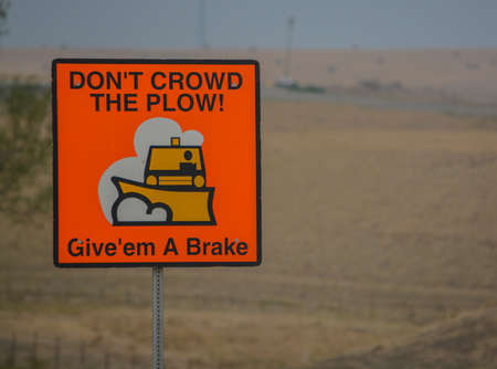 Don't crowd the plow sign when snow is being removed from the road in North Dakotaの写真素材