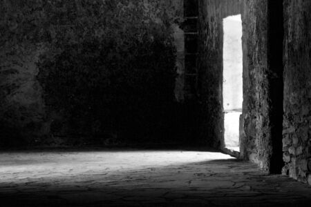 A rustic hall with sunlight spilling through the door.の写真素材
