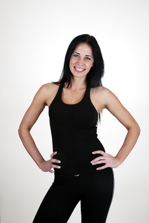 Healthy woman standing with hands on hips の写真素材