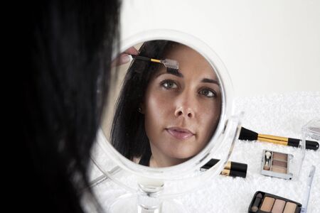 Woman applying make-upの写真素材