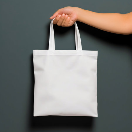 Person Hand Holding a White Blank Tote Bag in Front of a Minimal Background. Generative AI. high quality illustrationの素材