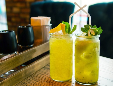 Two servings of fresh lemonade on the table of the summer cafe