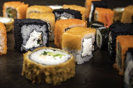 A lot of different rolls in the Japanese style on a dark surface, side view, with selective focusの写真素材