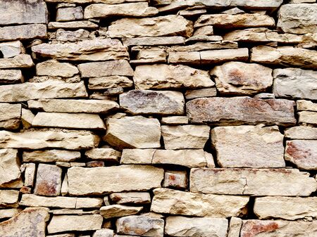 Fragment of masonry stone of light shades with natural lighting, close-up. Construction technology mountaineers of the Caucasus. Stone extracted from the rocks. Life of the Highlanderの写真素材