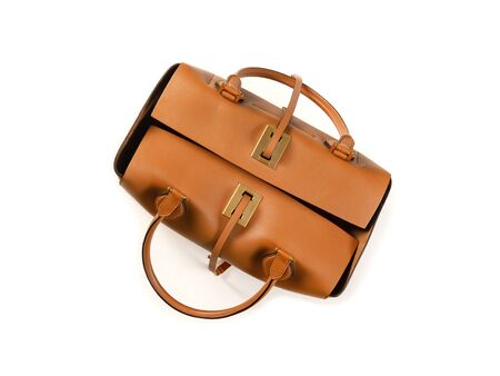 Yellow women's bag made of smooth leather with handles and leather straps on a white background. View from above. Minimalistic design. Isolateの写真素材