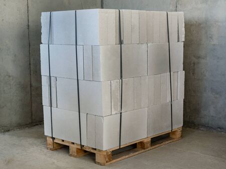 Packing aerated concrete blocks for partitions in the building under construction. The block lie on a wooden pallet, tightened with packing tapeの写真素材