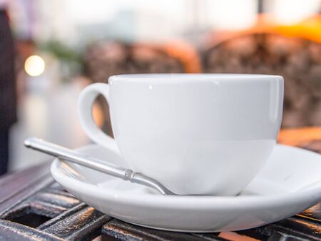 White coffee cup with saucer and teaspoon close-up. Selective focus, copyspaceの写真素材