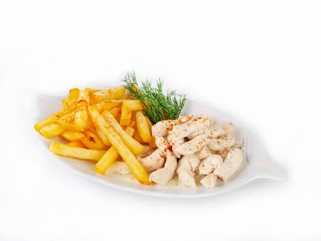 Sliced chicken in a creamy sauce on a plate with a side dish on a white background. Fried potatoes, dill. Close up, selective focusの写真素材