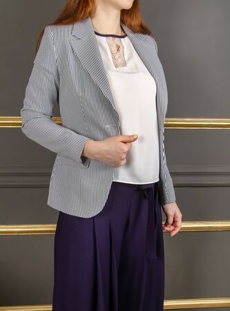 Demonstration of a spring outfit for a young woman. Without a face. Vertical positionの写真素材
