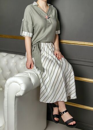 Blouse, skirt, light shoes. Folds. Summer clothes for the girl. Frivolous, casual, playful. Equilibrium. Faceless, Verticalの写真素材