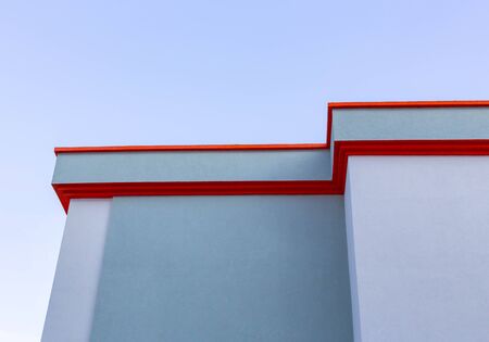Fragment of a modern building against a cloudless sky. Roof corniceの写真素材
