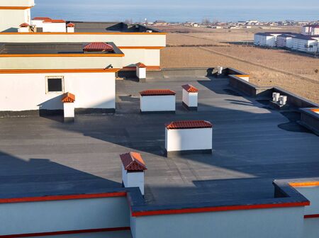 Several ventilation shafts are located throughout the roof of the buildingの写真素材