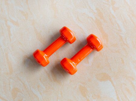 Fitness equipment. Small dumbbells, bright colors. Soft focus. Marble floorの写真素材