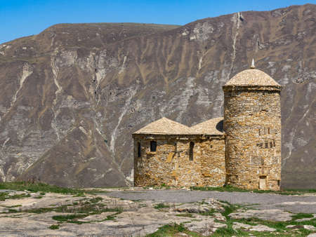 The building is made of stones of various shapes with windows of different sizes. The small dome is...