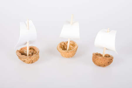 Three little boats made from walnut shell.の写真素材