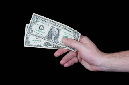 Male hand with dollar banknotes on black background