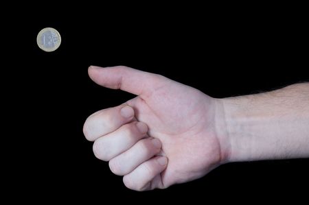 Male hand flipping away one Euro coin with thumb