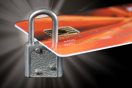 A bank credit card locked by a padlock with flareの写真素材