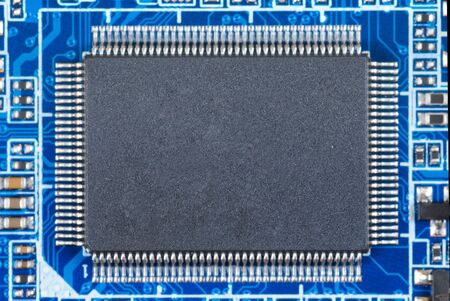 Detail of integrated circuit on blue board.