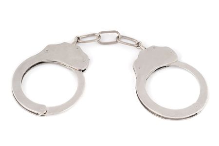 Silver metal handcuffs on white background.の写真素材