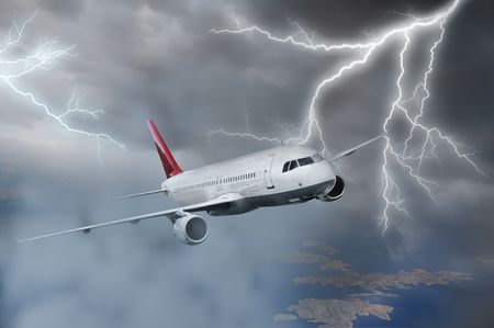Passenger airplane flying above sea on stormy skyの写真素材