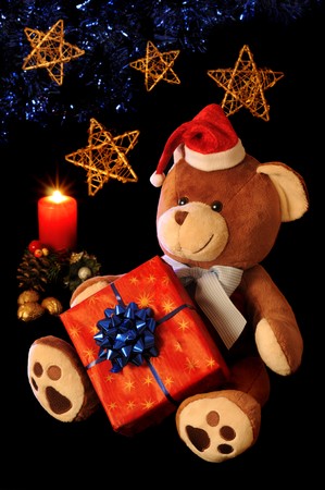 Christmas teddy bear with gift and holiday decoration.の写真素材