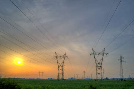 Sunset over Highvoltage power lines  in the land around Plovdiv Bulgaria