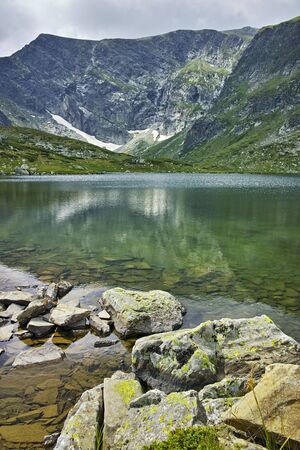 Reflection of Rila Mountain in The the Trefoil lake