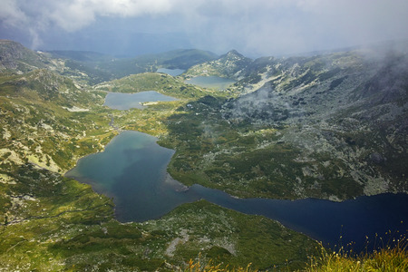 approaching clouds over The Twin, The Trefoil, the Fish and The Lower Lakes, The Seven Rila Lakes, Bulgariaの写真素材
