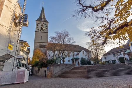 Amazing view of St. Peter Church and autumn trees, City of Zurich, Switzerlandの写真素材